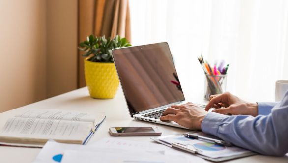 A man typing on a laptop